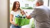 Man Offering Help To His Daughter Carrying Groceries