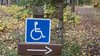 handicap sign for the forest hiking trail, trail direction in Kamloops near Isobel Lake. Accessible path for disabled, wheelchair.